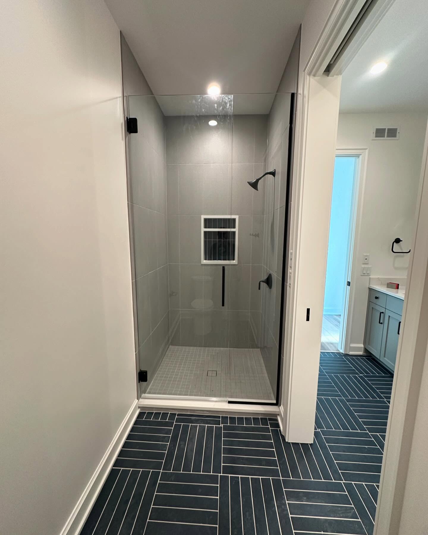 Herringbone tile floor in a custom shower