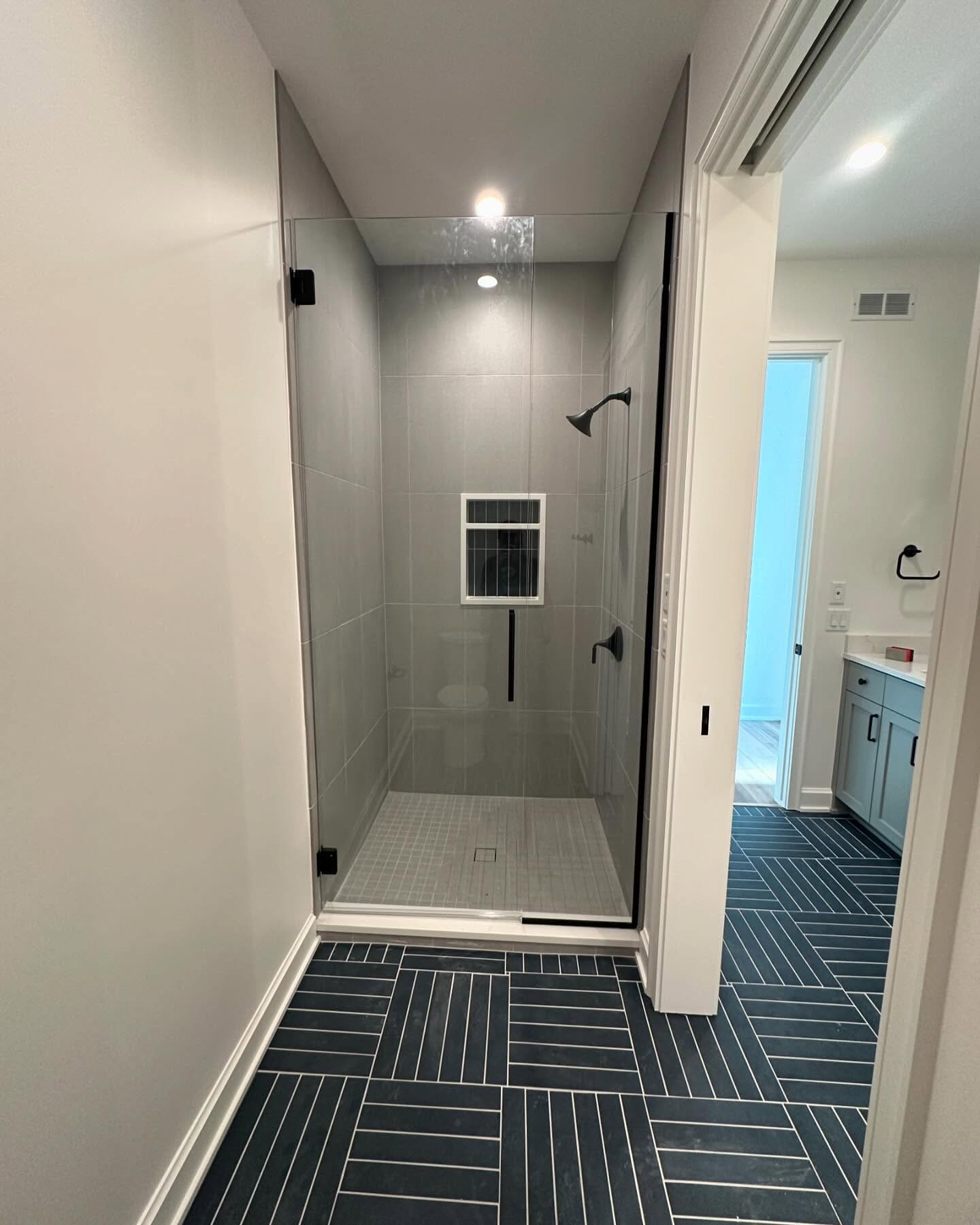 Walk-in shower with herringbone floor tile