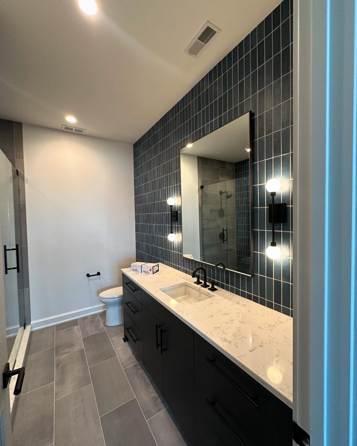 Teal stacked-tile vanity wall